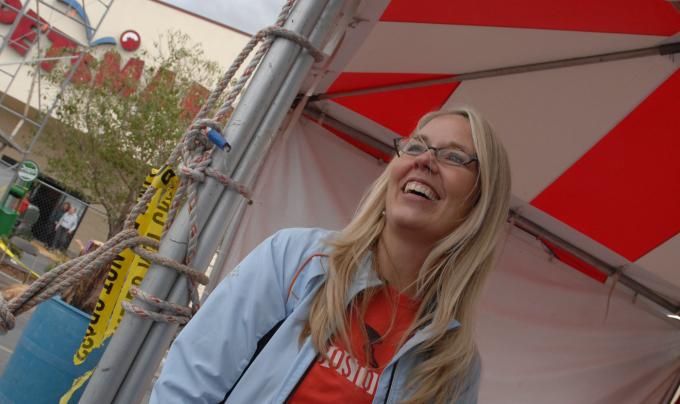 Best Friends CEO Julie Castle smiling at a booth at an event
