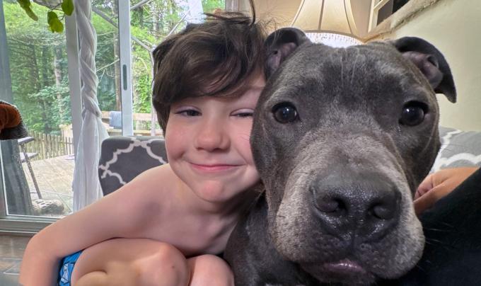 Gabriel the dog beside a child