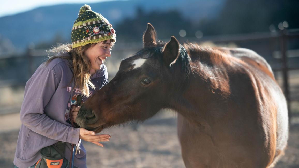 Shy DeLand playing hide-and-seek with Clint the horse