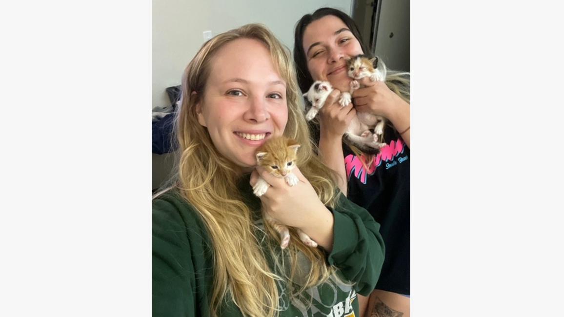 Emilie and Haley holding a litter of kittens