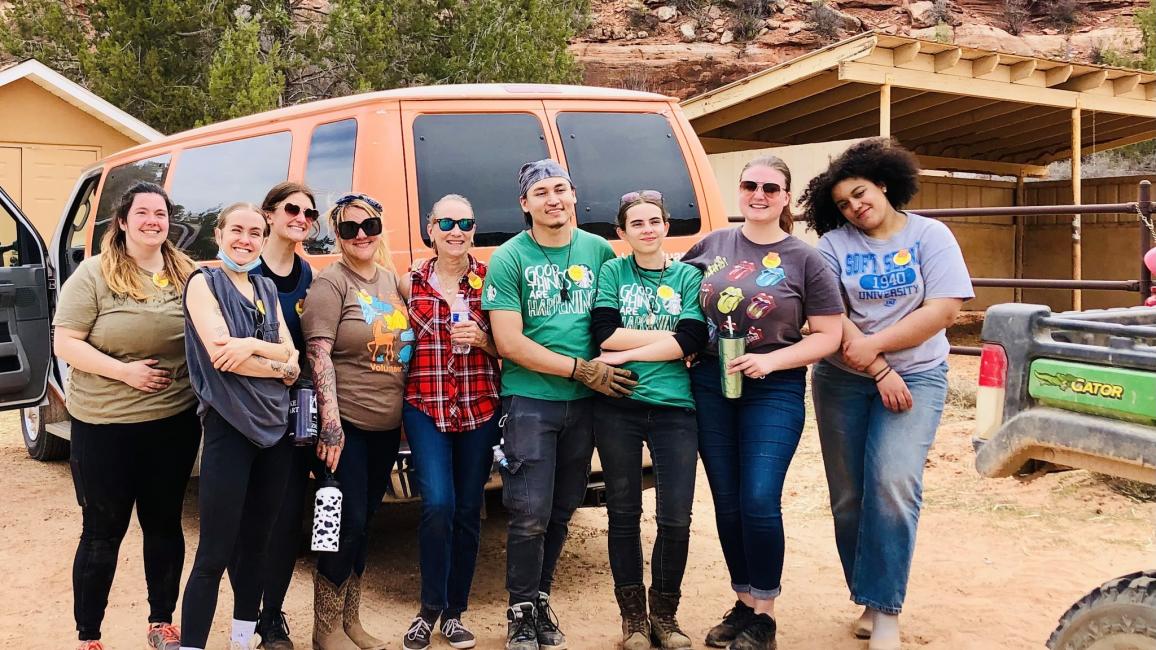 Starbucks volunteers at the Sanctuary outside behind a van