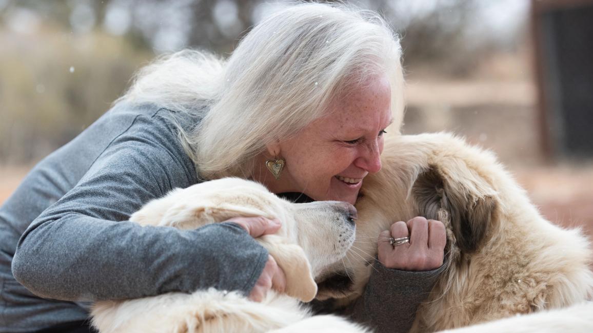 Val Hardin hugging Anna and Racer the dogs