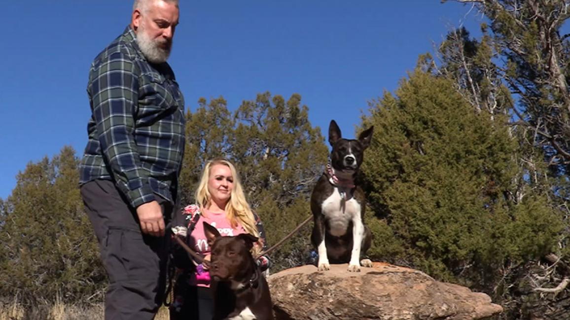 Scott Kroger and Felicia Summer outside on a walk with Summer Rain and Piney the dogs