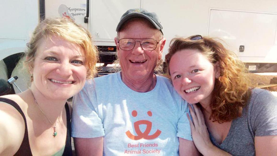 Volunteer Bill Splitter, smiling, between his two daughters Trischa and Elizabeth