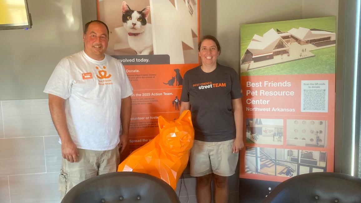 Volunteers Russ and Elizabeth Duszak in front of a display at the Best Friends Pet Resource Center in Northwest Arkansas