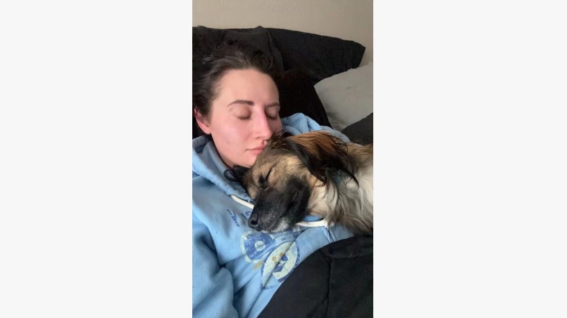 Mackenzie Wilhite sleeping with Nikki the dog on her chest