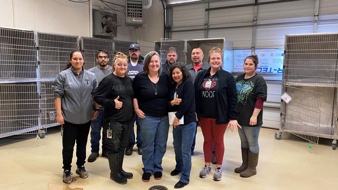 Staff from San Angelo Animal Services standing in front of empty kennels