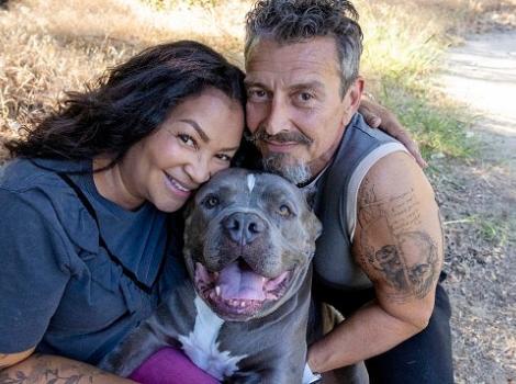 Couple with gray dog