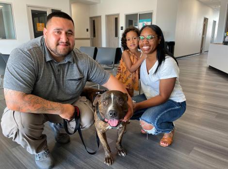 Mac the brindle dog being reunited with is family at Fresno Humane Animal Services