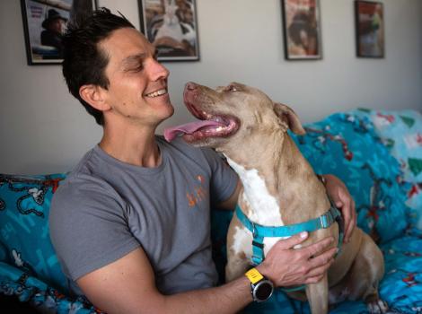Adam with Queenie the dog on a sleepover