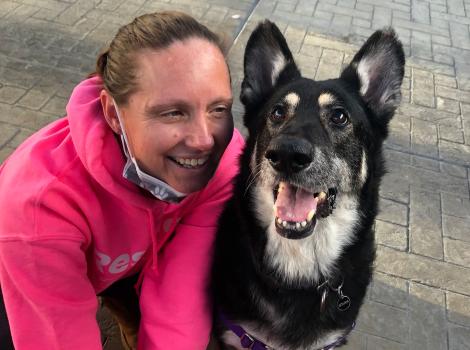 Smiling person next to Tanya the dog, who is also smiling
