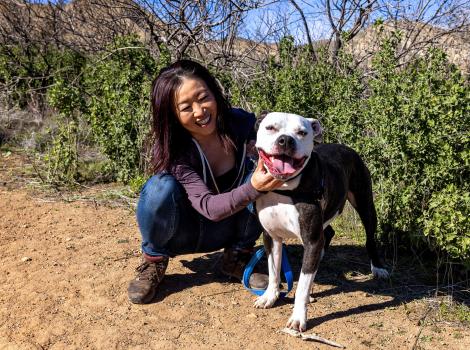 Nanami with Orion the dog and both are smiling