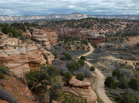Angel Canyon landscape of red cliffs with a road running through it