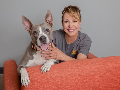 Smiling person wearing a Best Friends T-shirt next to a smiling dog with upright ears