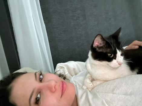 Lil the cat lying on Kelly's chest