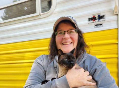 Stormy Shafer holding Abby the Siamese cat