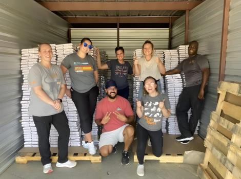 People in an area with pallets of pet food