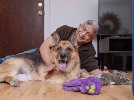 Jaime Gallardo lying on the floor with Dublin the dog