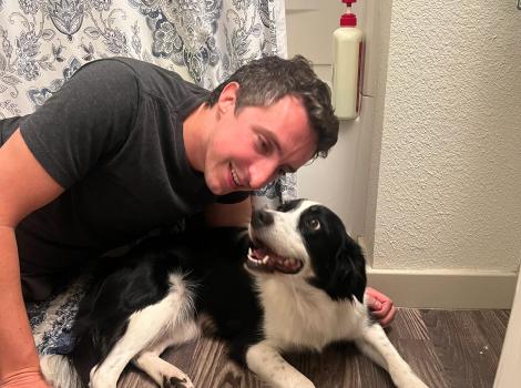 Alex on the floor with Ducky the dog