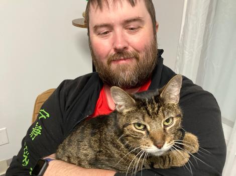 Erick Allen holding his cat Eddie