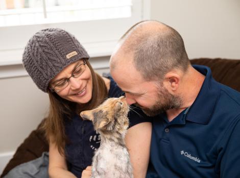 Alida and Gary Oldham with Cleopatra the cat, who is nose-to-nose with Gary