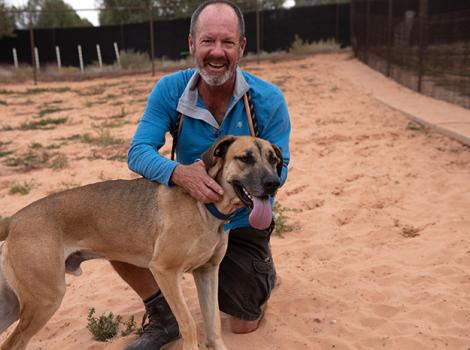 Southeast the dog being hugged by caregiver, Matt Fisher