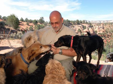 Francis Battista with multiple dogs outside in Angel Canyon