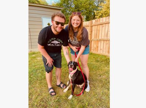 Golfy the dog from Pets of Ohio Rescue Team in a yard with his new family