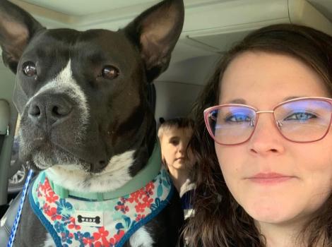 Ruby Fooks beside a dog in a vehicle