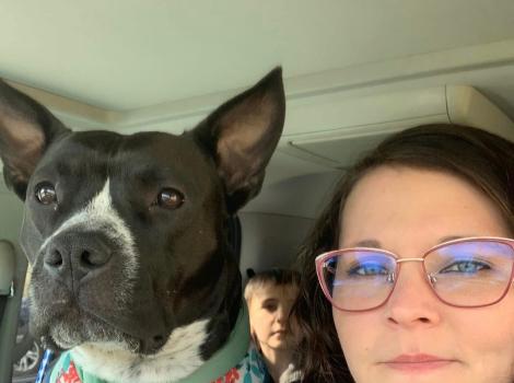 Ruby Fooks beside a dog in a vehicle