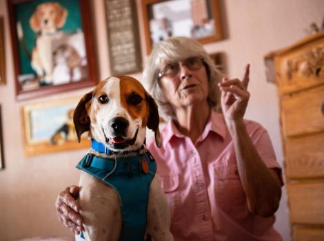 Elvis the dog next to Mary inside her house