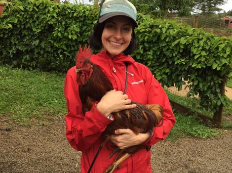 NKLA cat volunteer Mollie holding a rooster
