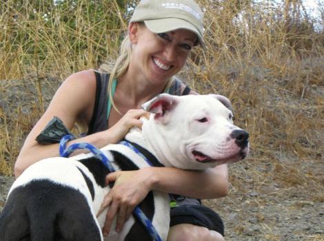 Volunteer Victoria Vertuga with a pit bull terrier