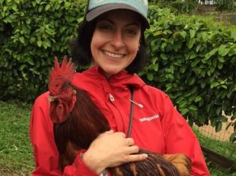 Volunteer Mollie with a rooster