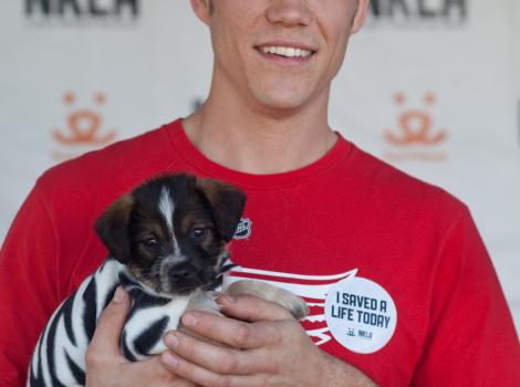 Man holding his adopted dog at the NKLA Adoption Weekend