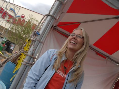 Best Friends CEO Julie Castle smiling at a booth at an event