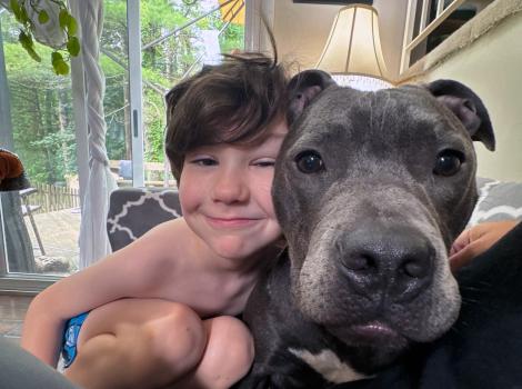 Gabriel the dog beside a child