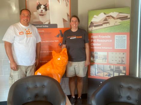 Volunteers Russ and Elizabeth Duszak in front of a display at the Best Friends Pet Resource Center in Northwest Arkansas