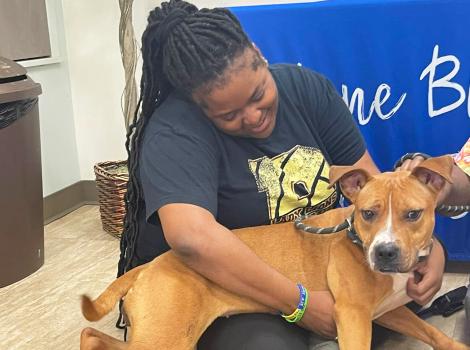Taylor Hill with Kiba the dog in her lap